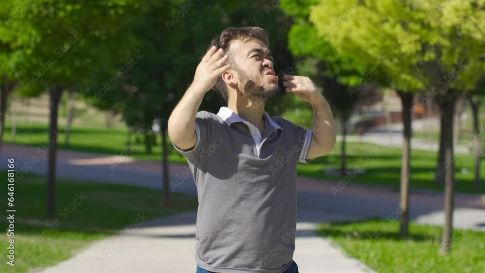 Dwarf young man is suffocating from sunny and hot weather outside. Dwarf young man is suffocating from sunny and hot weather outside.