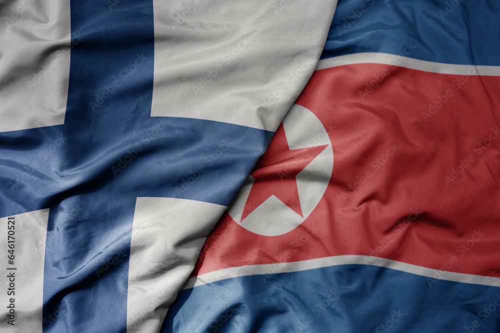 Fototapeta premium big waving national colorful flag of finland and national flag of north korea .