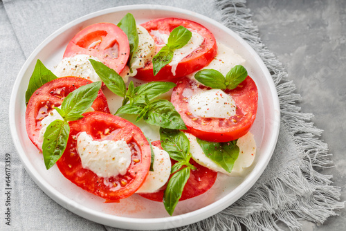 Caprese Salad Plated on White Plate with Stylish Gray Linen Napkin. Close up