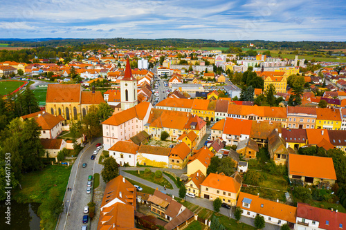 Picturesque autumn landscape of ancient Blatna downtown with reddish roofs of houses and gothic Bell Tower, Strakonice district, Czech Republic..