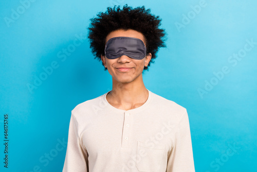 Photo of satisfied funky young person blindfold mask cover eyes sleep recreation isolated on blue color background
