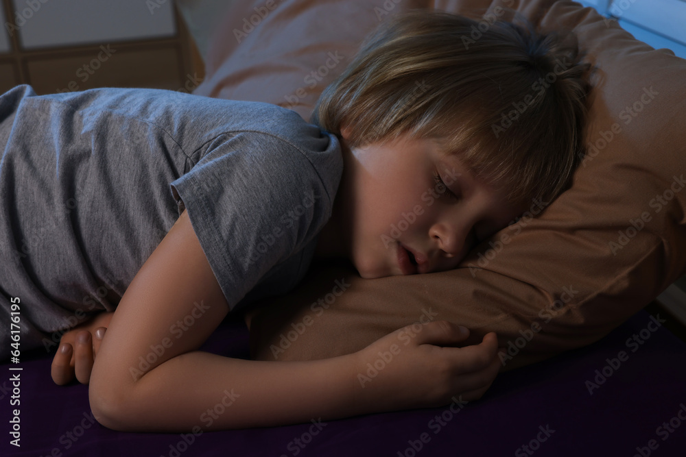 Little boy snoring while sleeping on bed at night Little boy snoring while sleeping on bed at night