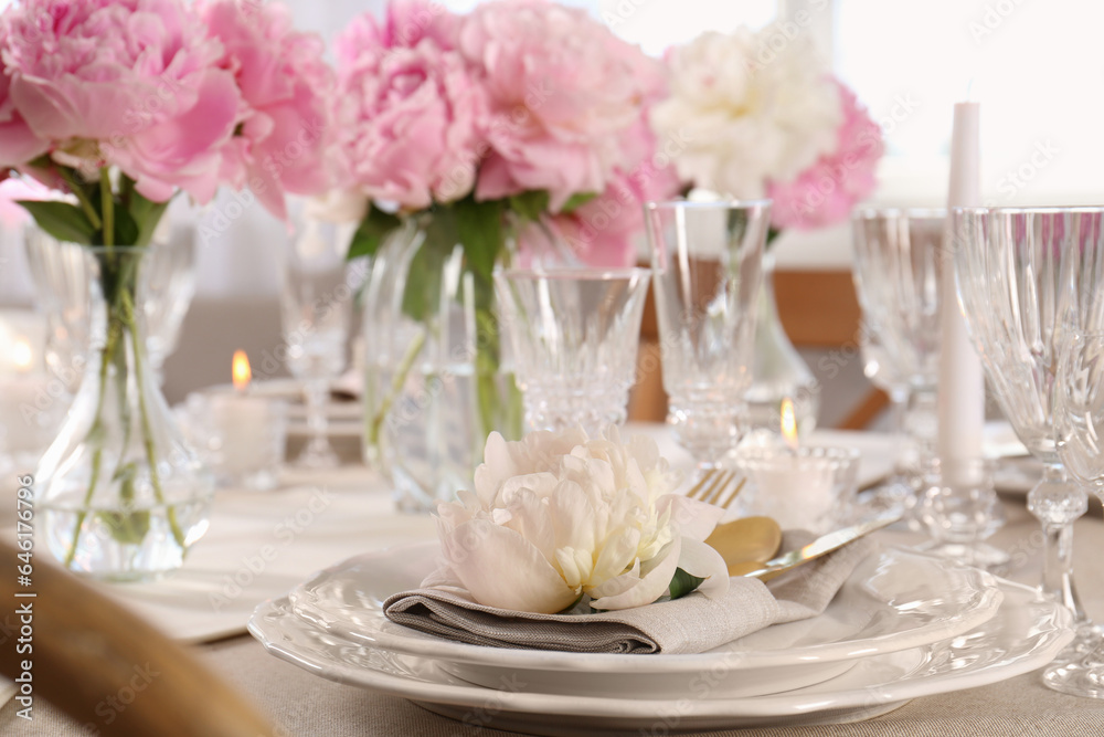 Stylish table setting with beautiful peonies indoors, closeup. Space for text