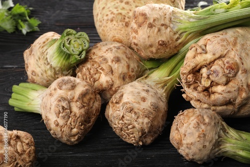 Fresh raw celery roots black wooden table