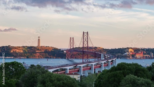 Time-lapse of Lisbon view from Miradouro do Bairro do Alvito tourist viewpoint with Tagus river, traffic on 25th of April Bridge and Christ the King statue on sunset. Lisbon, Portugal, Europe photo