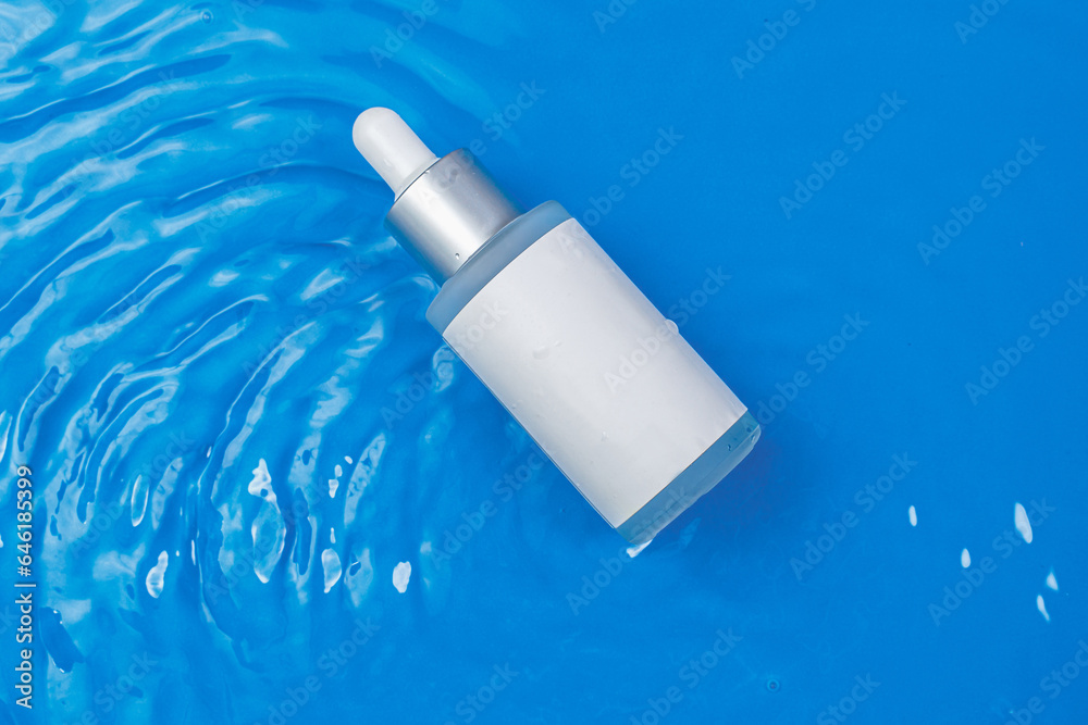 Facial essence bottle mockup. Serum to moisturize the skin. The bottle lies on a blue background in the waves. A daily treat for healthy skin. Anti edge cosmetics Facial essence bottle mockup. Serum to moisturize the skin. The bottle lies on a blue background in the waves. A daily treat for healthy skin. Anti edge cosmetics