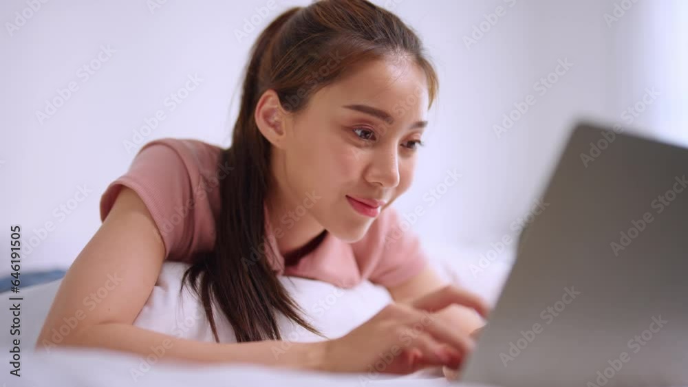 Asian attractive woman using laptop chat on bed at home in the morning. Asian attractive woman using laptop chat on bed at home in the morning.