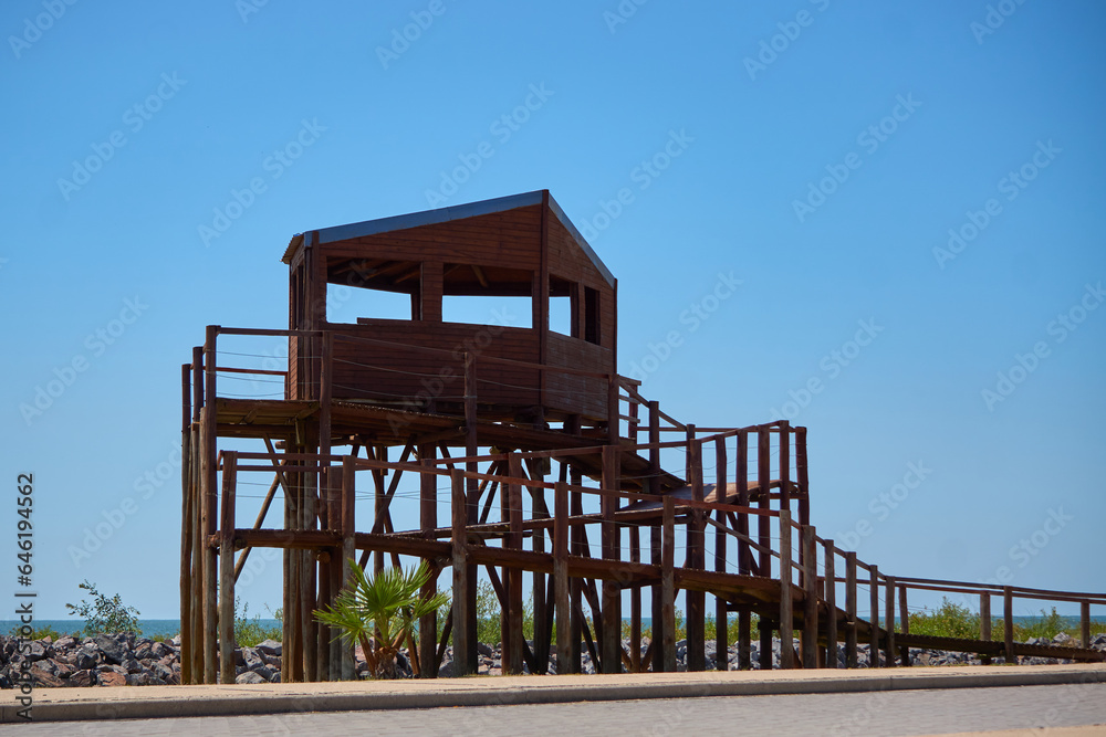 Birdwatcher's Wooden Oasis Beneath the Azure Sky Birdwatcher's Wooden Oasis Beneath the Azure Sky