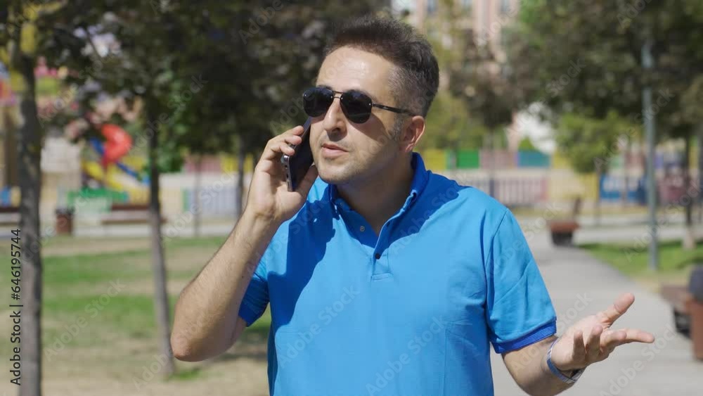 Outdoors man arguing with the person he's talking to on the phone. Outdoors man arguing with the person he's talking to on the phone.