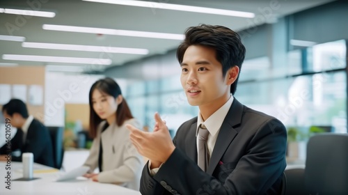 Asian businessman in modern office, Smiling and looking forward to the future innovations.