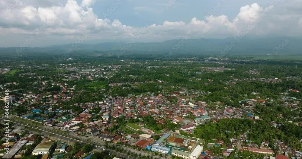 Cityscape with residential villages and highway, blue sky and clouds. Tagum City, Davao del Norte. Philippines. Cityscape with residential villages and highway, blue sky and clouds. Tagum City, Davao del Norte. Philippines.
