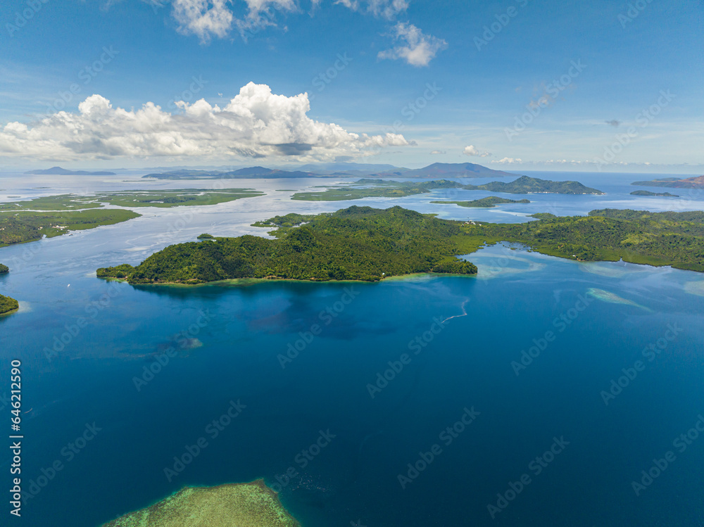 Tropical islands surrounded by blue water and sky landscape, travel concept. Mindanao, Philippines.