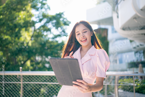 Shot of elegant young business woman smiling and  using tablet.
