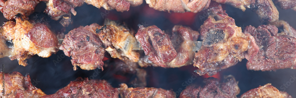 Top view of many metal skewers with meat in bbq grill. Top view of many metal skewers with meat in bbq grill.