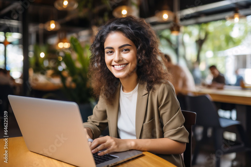 Indian student girl smile using laptop  study online hybrid learning