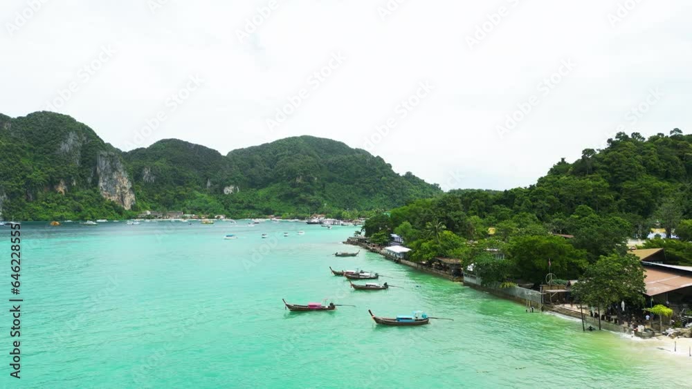 Aerial View of Long Tail Boats Floating Along The Seashore of Phi Phi Island In Thailand. Aerial View of Long Tail Boats Floating Along The Seashore of Phi Phi Island In Thailand.