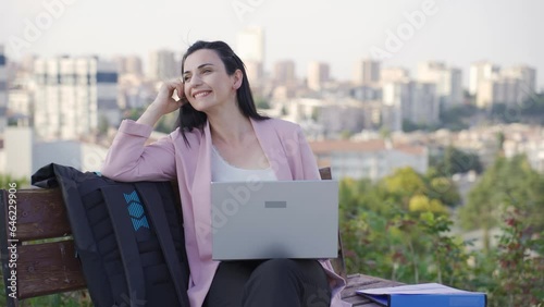 Businesswoman daydreaming outdoors in the park. photo