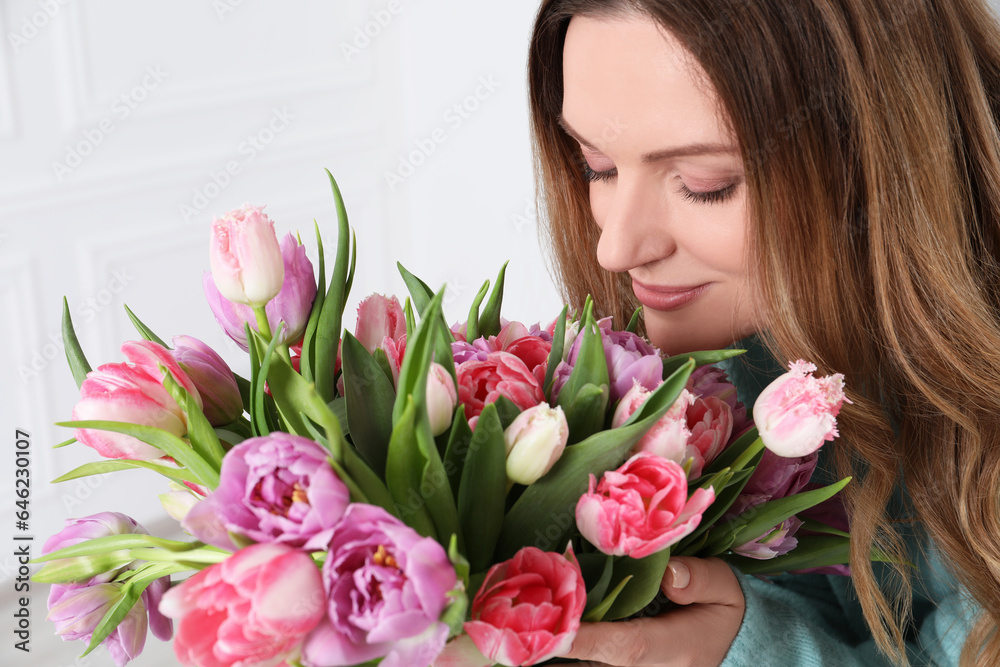 Young woman with bouquet of beautiful tulips indoors, closeup Young woman with bouquet of beautiful tulips indoors, closeup