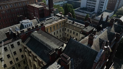 Aerial drone flight over the Sackville Building rooftop in Manchester City Centre photo