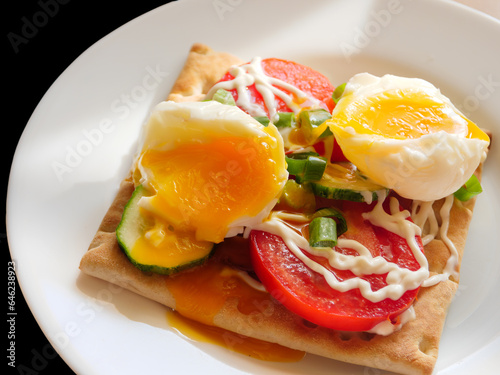 Bread with cutted boiled egg, sliced red tomatoes and fresh green onion.