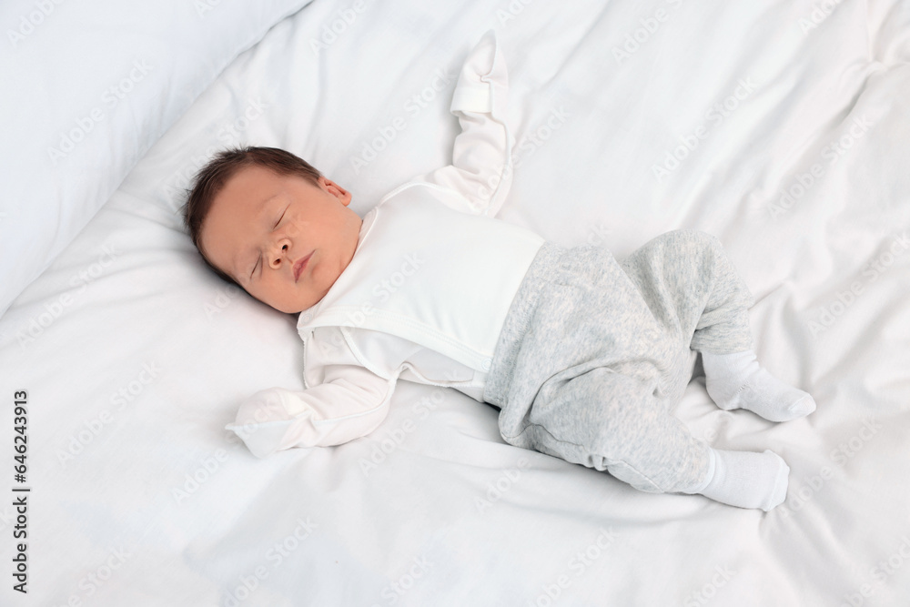 Cute newborn baby sleeping on white soft bed Cute newborn baby sleeping on white soft bed