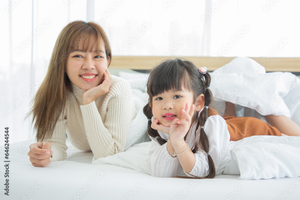 Happy loving family. Asian mother and her daughter child girl playing in bedroom. Happy loving family. Asian mother and her daughter child girl playing in bedroom.