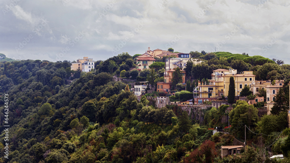 Glimpse of the lush hilly landscape and Castel Gandolfo village located at Lake Albano slopes in Italy