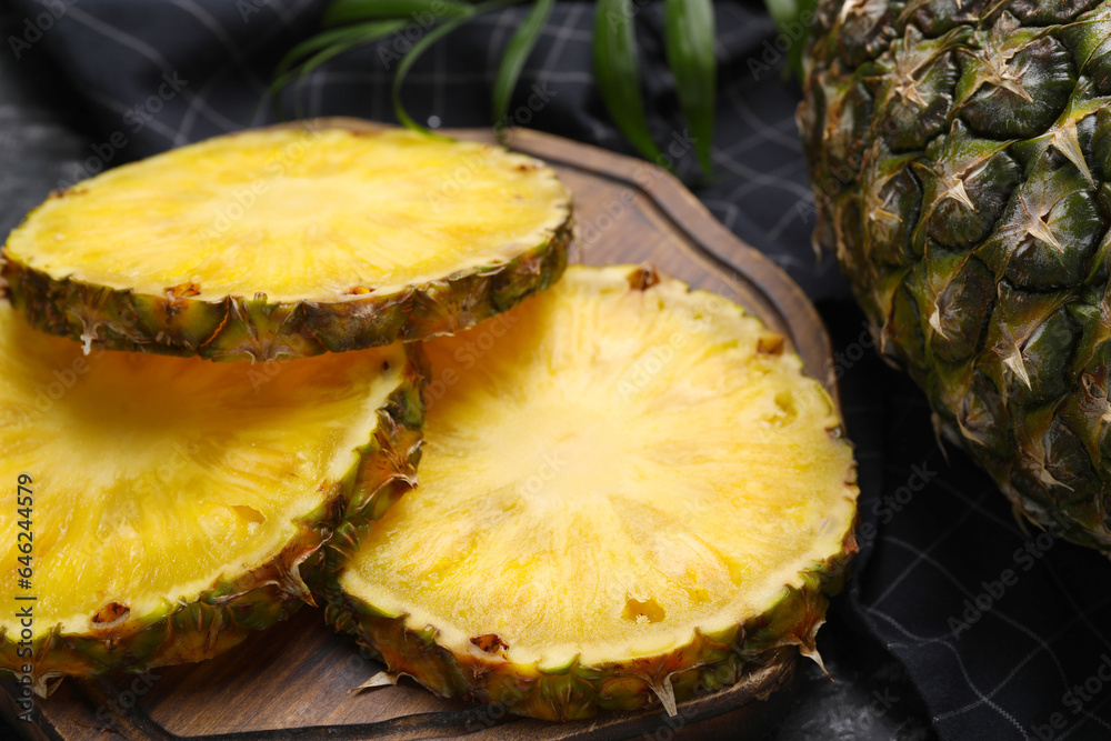 Slices of tasty ripe pineapple on table, closeup Slices of tasty ripe pineapple on table, closeup