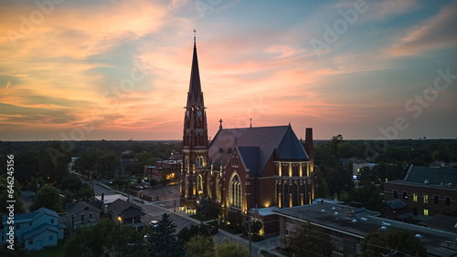 A large Catholic church in the suburbs at sunset. Aerial shot