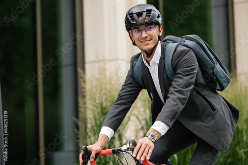 Businessman riding a bike and looking contented photo