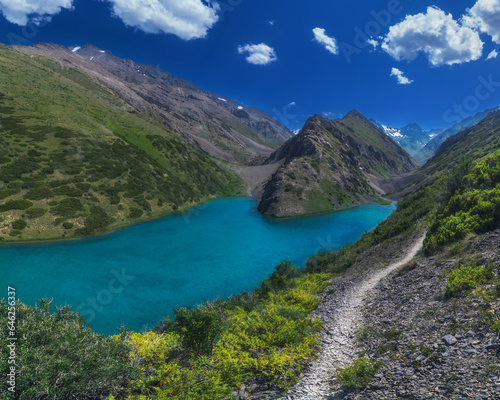 Panorama landscape with a blue lake in the mountains in summer. Koksai Ainakol Lake in Tien Shan Mountains in Asia in Kazakhstan