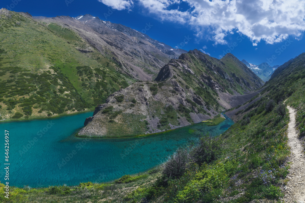 Panorama landscape with a blue lake in the mountains in summer. Koksai Ainakol Lake in Tien Shan Mountains in Asia in Kazakhstan
