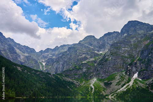 Amazing view on mountains range near beautiful lake at summer day. Tatra National Park in Poland. Panoramic view on Morskie Oko or Sea Eye lake in Five lakes valley