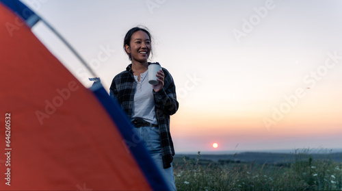 young beautiful woman enjoying her refreshments and the view after a long hiking day