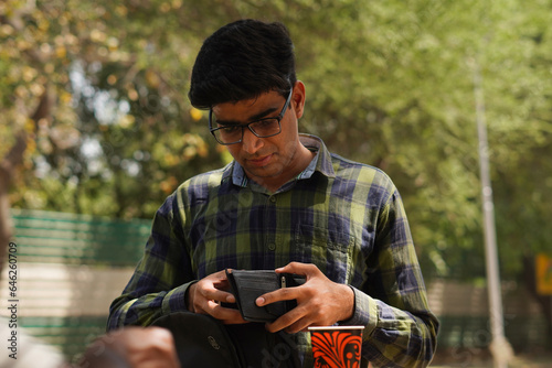 Young Indian middle class young man drinking juice from roadside vendor