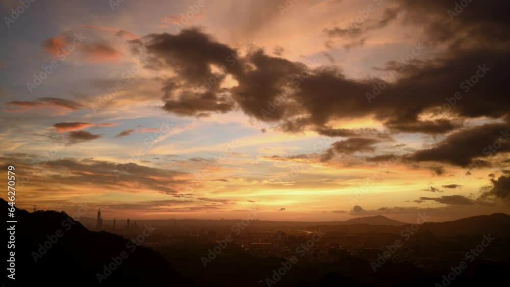 Fantasy orange sky. The vibrant and bustling night scene of Taipei City. Night view of the city surrounded by mountains is hazy and dreamy. Dajianshan, Taiwan