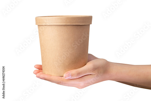 Hand holds craft paper soup cup on isolated background.