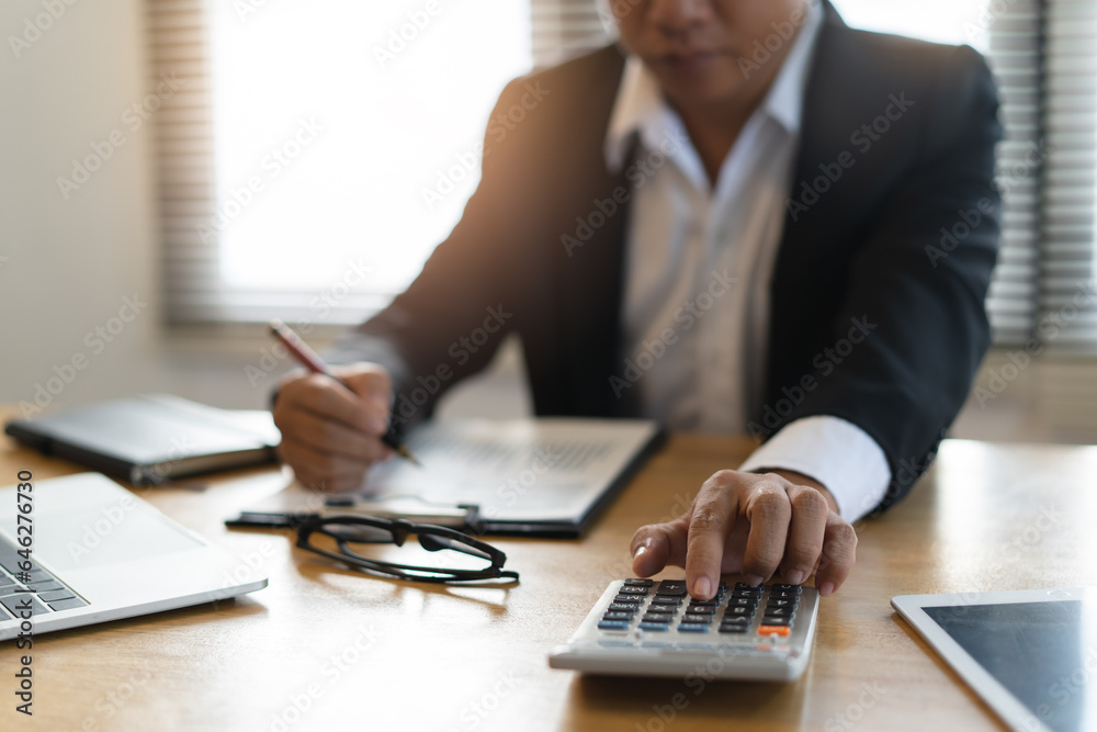 Close up view of hands of businessman use calculator calculate financial of business. Close up view of hands of businessman use calculator calculate financial of business.