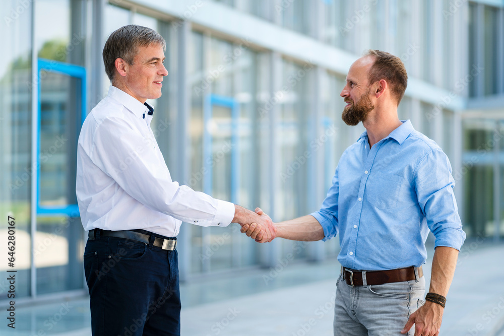 Business partners shaking hands after successful meeting Business partners shaking hands after successful meeting