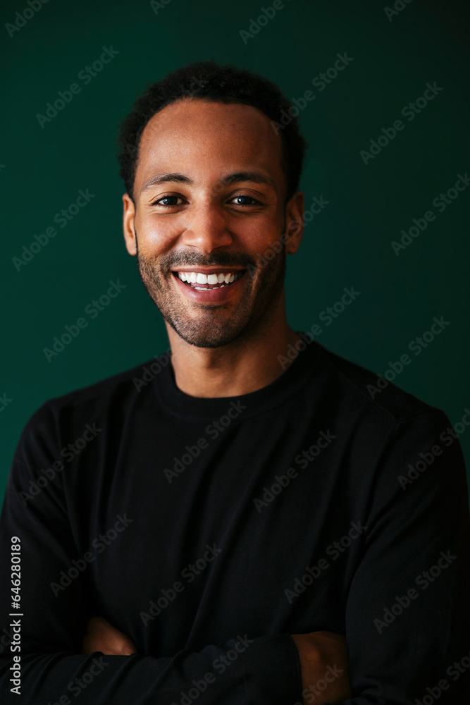 Smiling man with arms crossed in front wall Smiling man with arms crossed in front wall