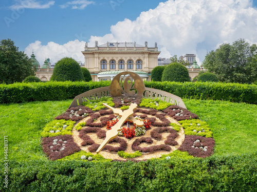 August 5, 2023, Austria, Vienna Clock made of flowers against the backdrop of a music hall Kursalon Hubner in a city park Stadtpark. photo