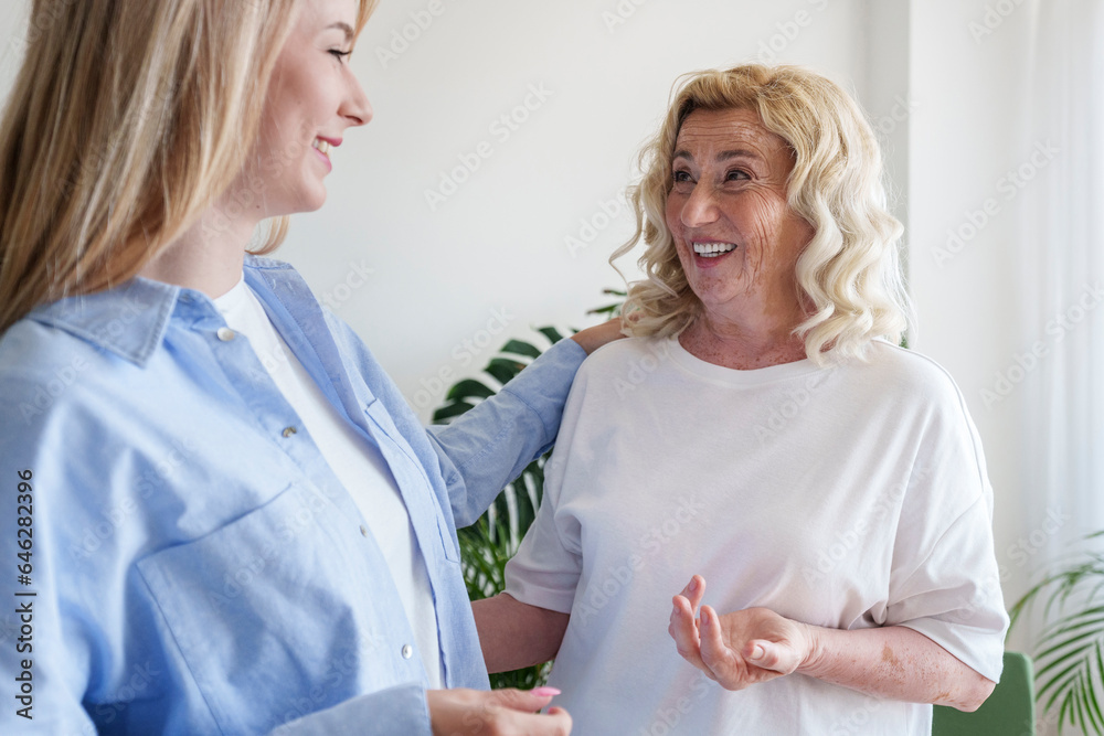 Happy mother talking with daughter at home Happy mother talking with daughter at home