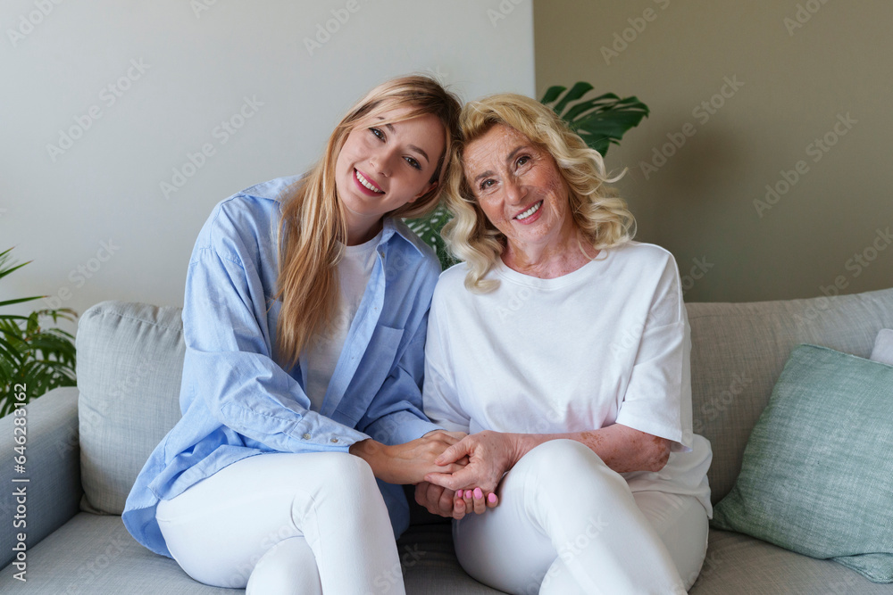 Happy mother holding hands with daughter at home Happy mother holding hands with daughter at home