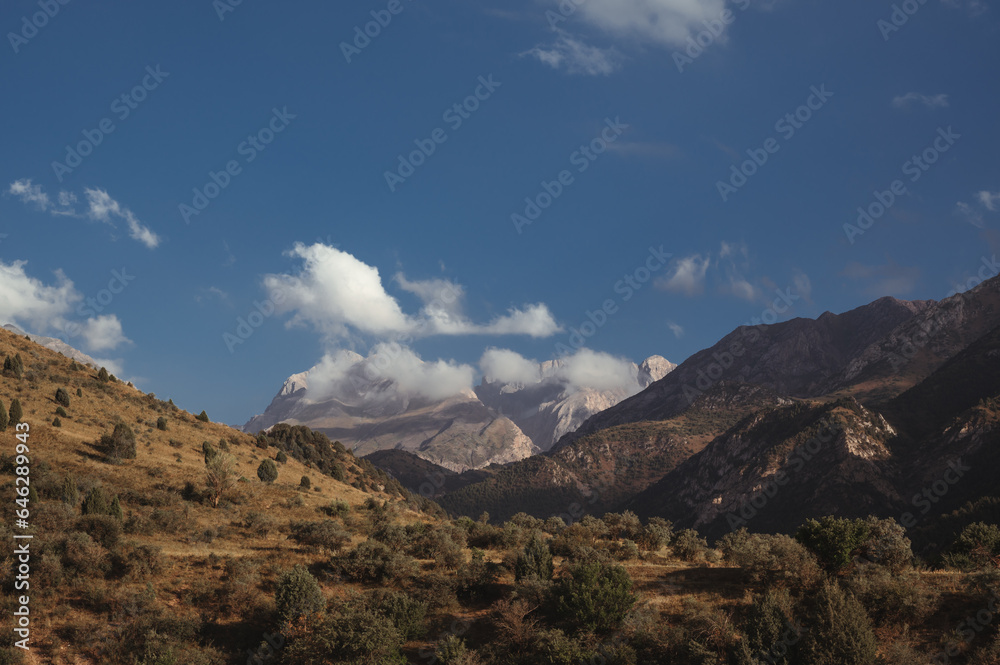 landscape with mountain peaks background the sky with clouds at sunset in a summer landscape with mountain peaks background the sky with clouds at sunset in a summer
