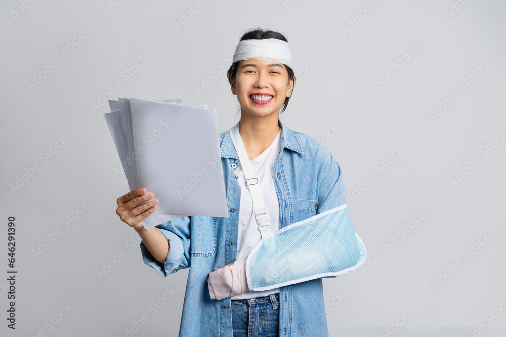 Accident. Woman wearing a plaster cast and arm sling support while holding medical bills Accident insurance or medical expenses concept. Accident. Woman wearing a plaster cast and arm sling support while holding medical bills Accident insurance or medical expenses concept.