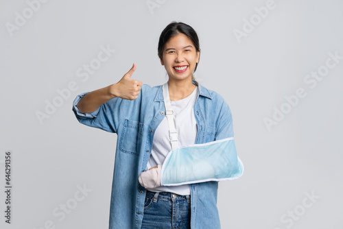 Asian female patient wearing plaster cast and arm support after injury from accident Life and accident insurance photo