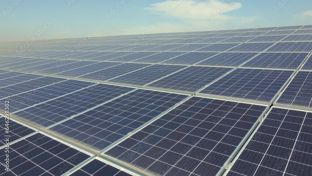 Aerial view of blue photovoltaic solar panels mounted on industrial building roof for producing green ecological electricity. Production of sustainable energy concept Aerial view of blue photovoltaic solar panels mounted on industrial building roof for producing green ecological electricity. Production of sustainable energy concept