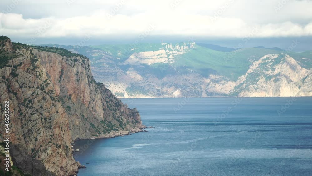 Aerial view on calm azure sea and volcanic rocky shores. Small waves on water surface in motion blur. Nature summer ocean sea beach background. Nobody. Holiday, vacation and travel concept Aerial view on calm azure sea and volcanic rocky shores. Small waves on water surface in motion blur. Nature summer ocean sea beach background. Nobody. Holiday, vacation and travel concept