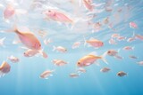 A glittering school of fish gracefully swim through the depths of the aquarium, their fins cutting through the water like a wild and vibrant dance