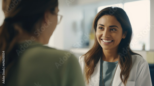 medicine, healthcare and people concept - female doctor with clipboard talking to smiling woman patient at hospital 